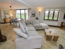 A living room with a sofa and coffee table at Little Acre in Church Lench near Harvington
