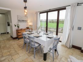 A dining room with a table set for dinner at Little Acre in Church Lench near Harvington