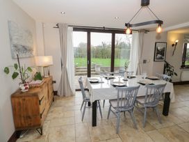 A dining room with a table and chairs at Little Acre, Church Lench near Harvington