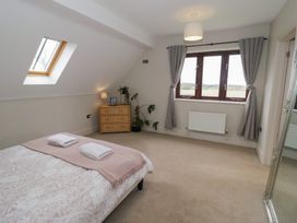 A bedroom with a bed and window at Little Acre, Church Lench near Harvington