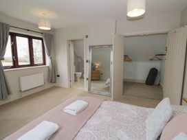A bedroom with a bed and window at Little Acre Church Lench near Harvington