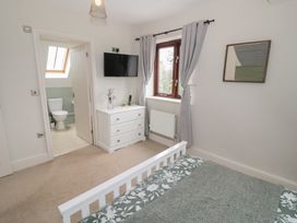 A bedroom with a bed and dresser at Little Acre in Church Lench near Harvington