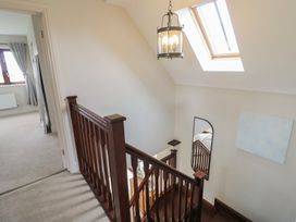 A staircase with a light fixture and a window in the hallway at Little Acre in Church Lench near Harvington