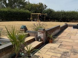 A garden with paving stones and plants at Little Acre Church Lench near Harvington