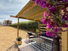 An outdoor seating area with a sofa and table at Little Acre in Church Lench near Harvington