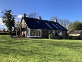 A house with a balcony and windows at Bryn Isaf in Ystrad Meurig