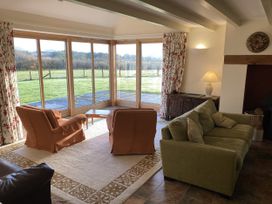 A living room with a view of the outdoors at Bryn Isaf in Ystrad Meurig