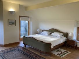 A bedroom with a bed and nightstand at Bryn Isaf in Ystrad Meurig