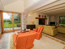 A living room with sofas and a coffee table at Bryn Isaf in Swyddffynnon near Pontrhydfendigaid