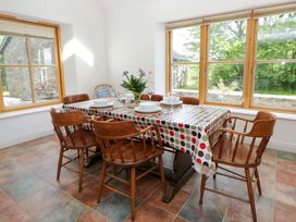 A dining room with a table and chairs at Bryn Isaf in Swyddffynnon near Pontrhydfendigaid