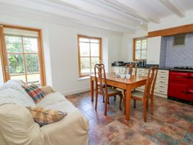 A kitchen with a dining table and sofa at Bryn Isaf in Swyddffynnon near Pontrhydfendigaid