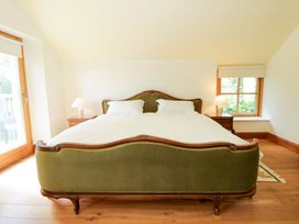 A bedroom with a bed and side table at Bryn Isaf in Swyddffynnon near Pontrhydfendigaid