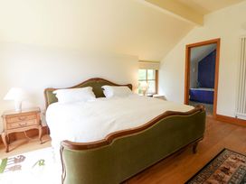 A bedroom with a bed and nightstand at Bryn Isaf in Swyddffynnon near Pontrhydfendigaid