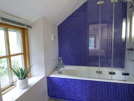 A bathroom with a bathtub and a window at Bryn Isaf in Swyddffynnon near Pontrhydfendigaid