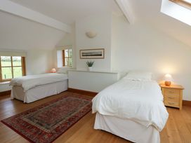 A bedroom with two beds and a window at Bryn Isaf, Swyddffynnon near Pontrhydfendigaid