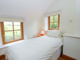 A bedroom with a bed and window at Bryn Isaf in Swyddffynnon near Pontrhydfendigaid