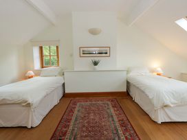 A bedroom with two beds and a window at Bryn Isaf in Swyddffynnon near Pontrhydfendigaid