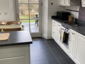 A kitchen with a table and chairs at Ty Cellin in Ystrad Meurig