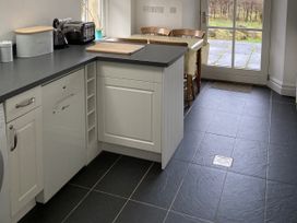 A kitchen with a door leading outside at Ty Cellin in Ystrad Meurig