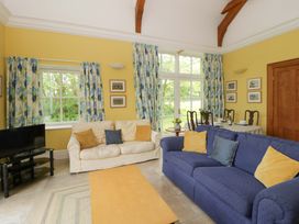 A living room with a sofa and television at Ty Cellin in Swyddffynnon near Pontrhydfendigaid