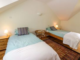 A bedroom with two beds and a lamp at Ty Cellin near Pontrhydfendigaid