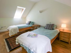 A bedroom with two beds and a book on one bed at Ty Cellin near Swyddffynnon near Pontrhydfendigaid