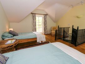A bedroom with two beds and a window at Ty Cellin in Swyddffynnon near Pontrhydfendigaid