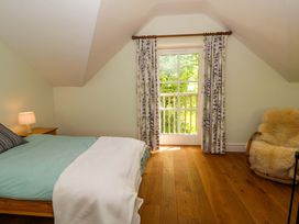 A bedroom with a bed and window at Ty Cellin in Swyddffynnon near Pontrhydfendigaid