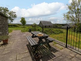 An outdoor area with a table and benches at Cwtch in Swyddffynnon near Pontrhydfendigaid