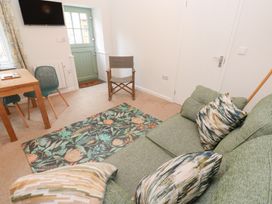 A living room with a sofa and dining table at Mys Hedra Farm St Buryan