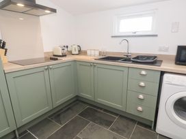 A kitchen with cabinets and appliances at Mys Hedra Farm St Buryan