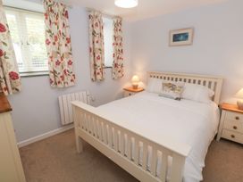 A bedroom with a bed and bedside tables at Mys Hedra Farm in St Buryan