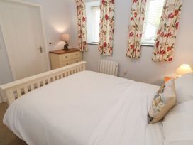 A bedroom with a bed and dresser at Mys Hedra Farm in St Buryan
