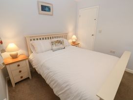 A bedroom with a bed and nightstands at Mys Hedra Farm St Buryan