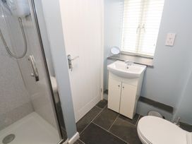 A bathroom with a shower, sink, and toilet at Mys Hedra Farm in St Buryan