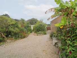A garden path with plants and a shed at Mys Hedra Farm St Buryan