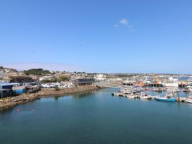 A harbor with boats and buildings at Mys Hedra Farm in St Buryan