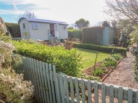 A shepherd hut in a garden area at Higher Merther Farm Shepherds Hut Helston
