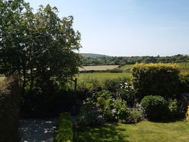 A garden with trees and bushes at Higher Merther Farm Shepherds Hut Sithney near Helston