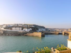 A view of a harbor with houses and flowers at Higher Merther Farm Shepherds Hut in Sithney near Helston