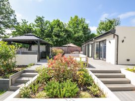A garden with a gazebo and hot tub at Boathyde in Northam
