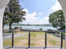 A view from a balcony overlooking water and grass at Boathyde Northam