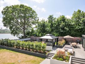 A garden with a gazebo, chairs and garden beds at Boathyde in Northam