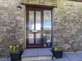 An entrance door with planters on each side at The Hayloft in Common Moor near Liskeard