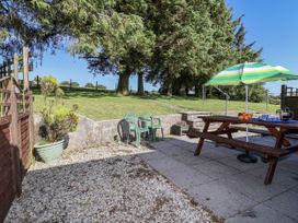 A patio area with a table and chairs at The Hayloft Common Moor near Liskeard