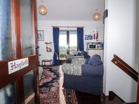 A living room with sofa and table at The Hayloft in Common Moor near Liskeard