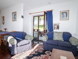 A living room with a sofa and table at The Hayloft Common Moor near Liskeard