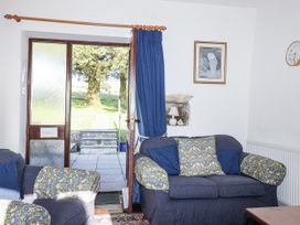 A living room with a door leading outside at The Hayloft in Common Moor near Liskeard