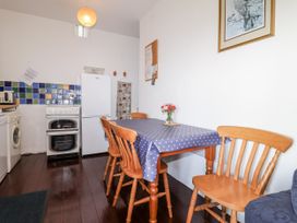 A kitchen with a table and chairs at The Hayloft Common Moor near Liskeard
