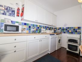 A kitchen with appliances and cabinets at The Hayloft in Common Moor near Liskeard